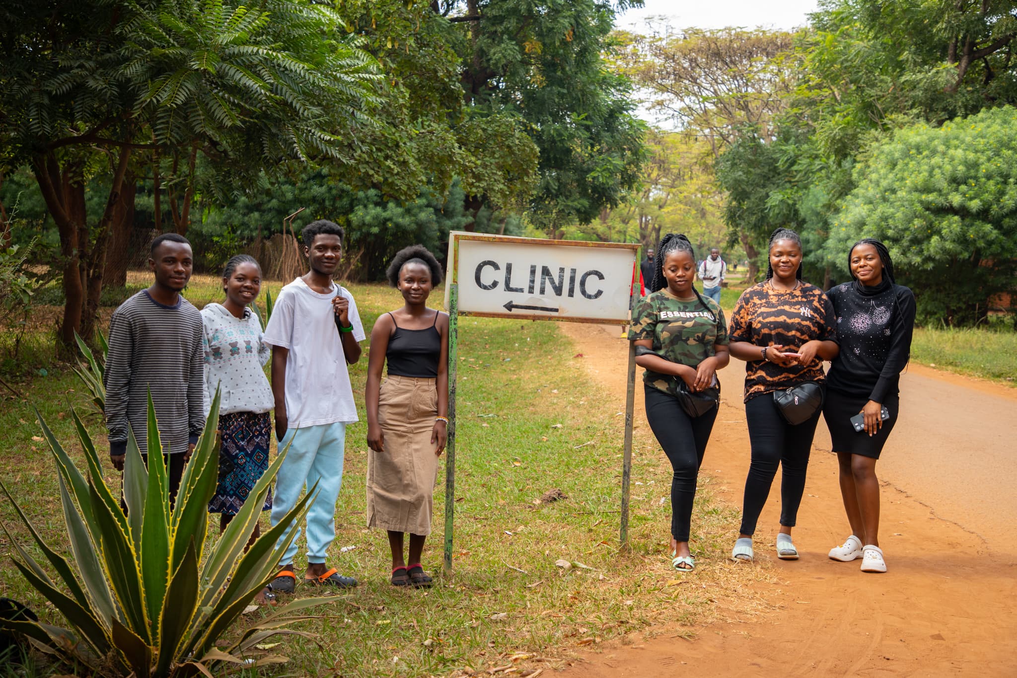 Students gathered outside near a clinic sign